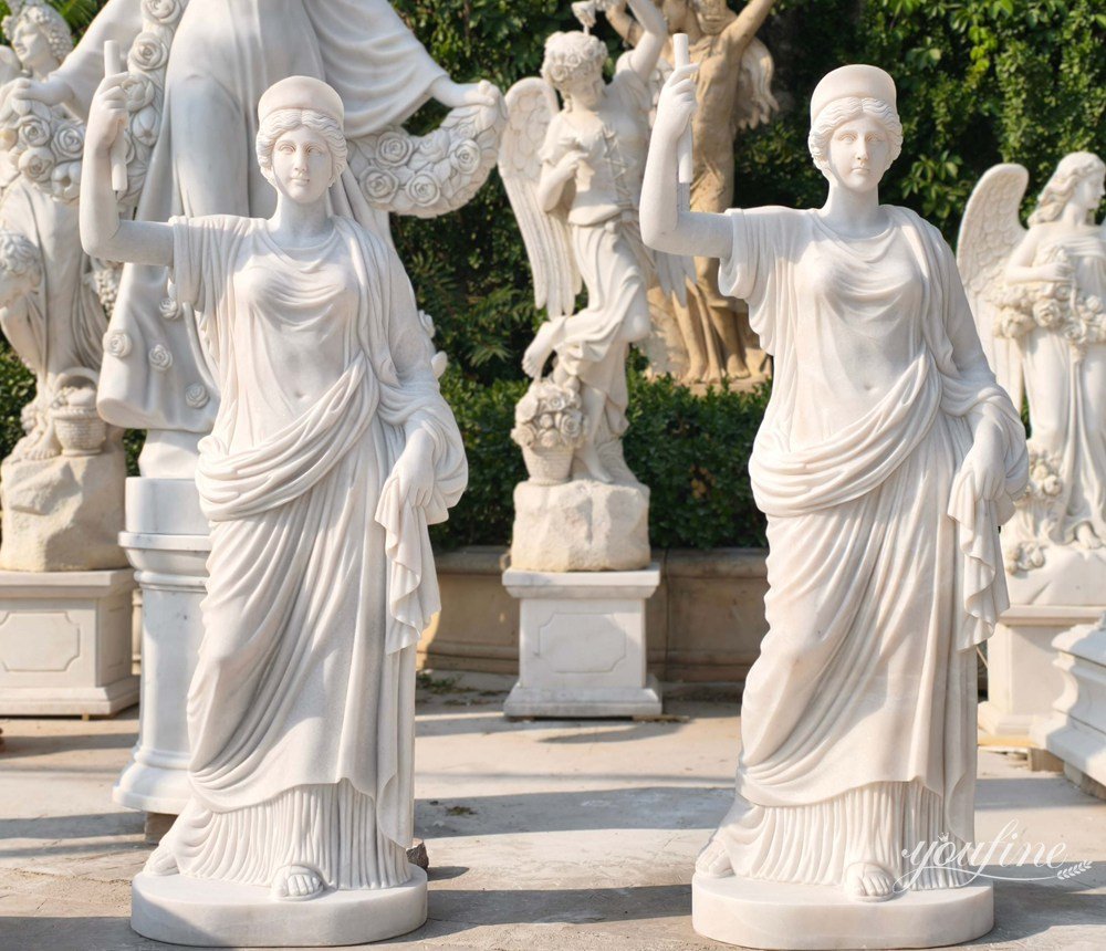 A pair of marble female warrior statues