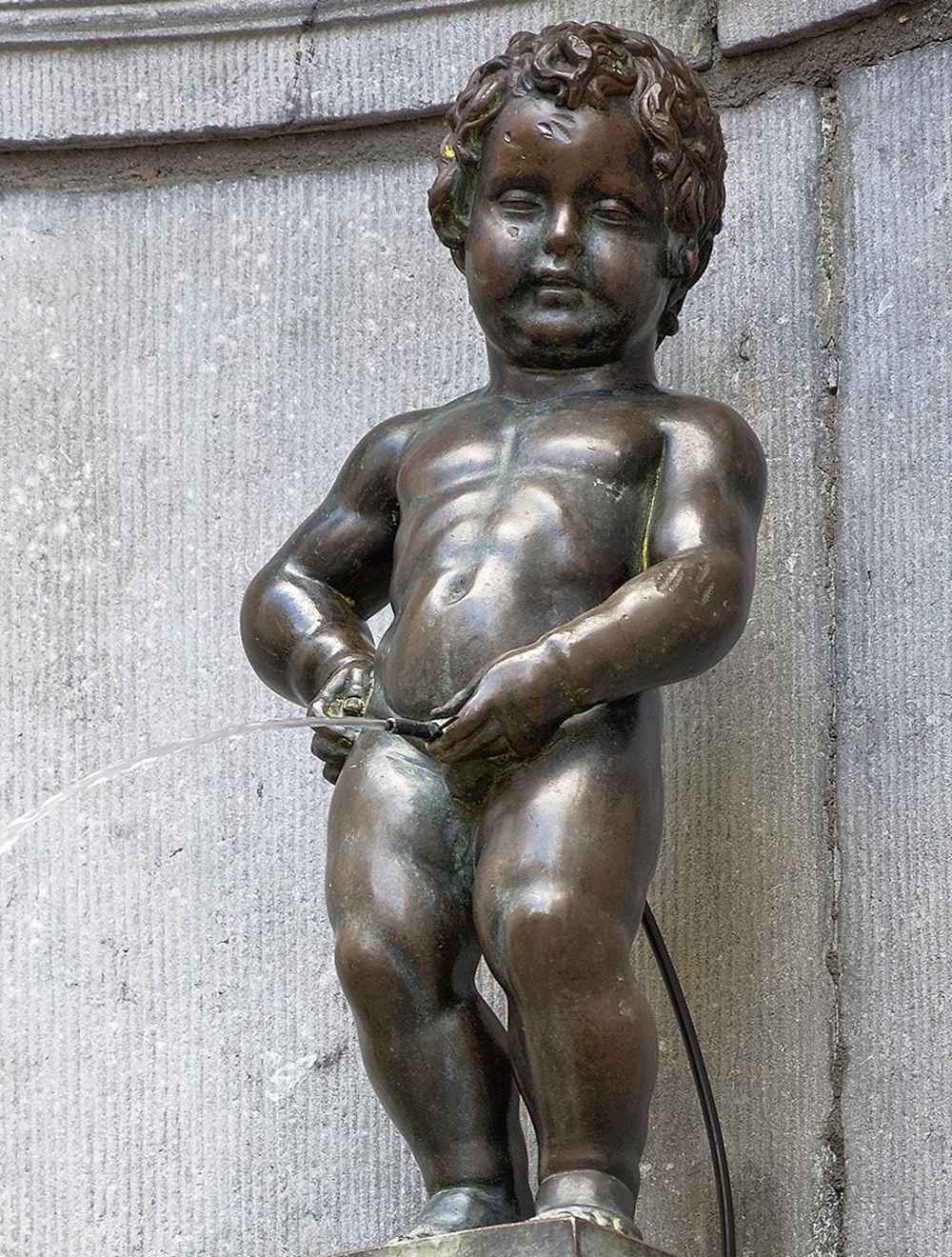 Manneken Pis in Brussels is a historic and famous bronze statue fountain.