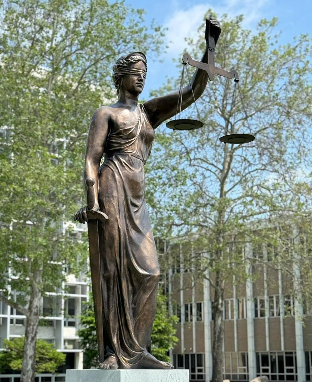 The bronze statue of the goddess of justice is located at the Michigan State Courthouse