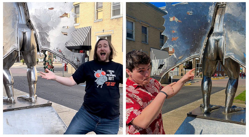 Tourists interacting with the Mothman statue