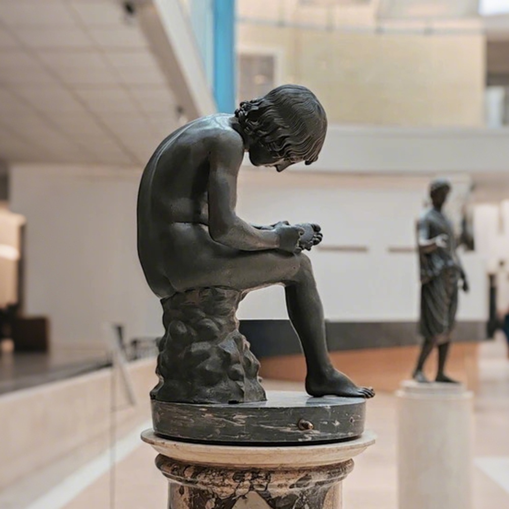 bronze boy with thorn statue