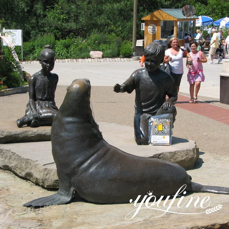 bronze sea lion and child statue