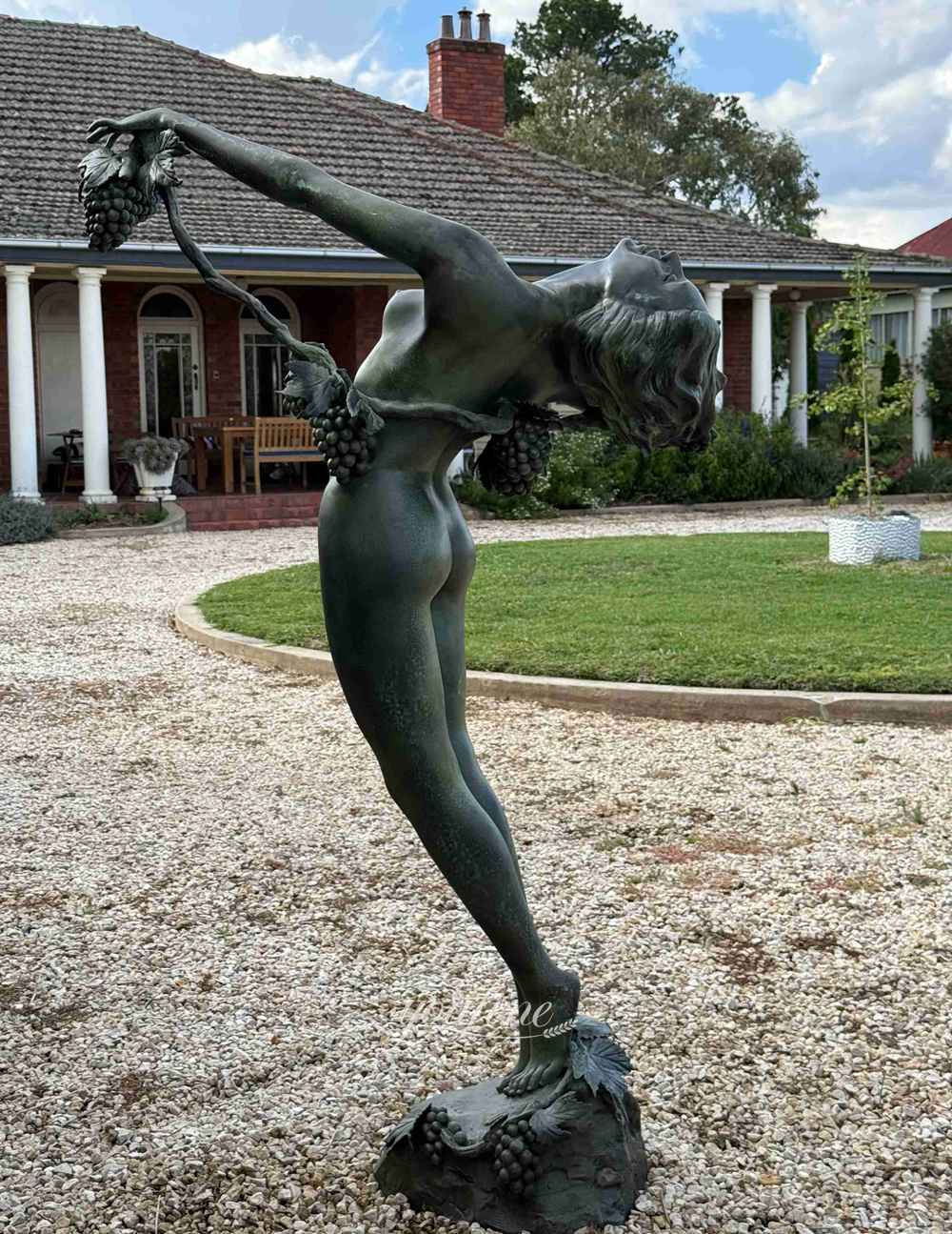 bronze vine-covered female sculpture with dark green patina color