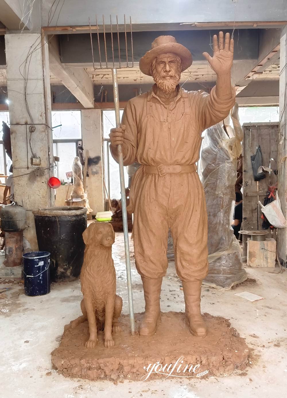 clay model of the bronze farmer and dog statue