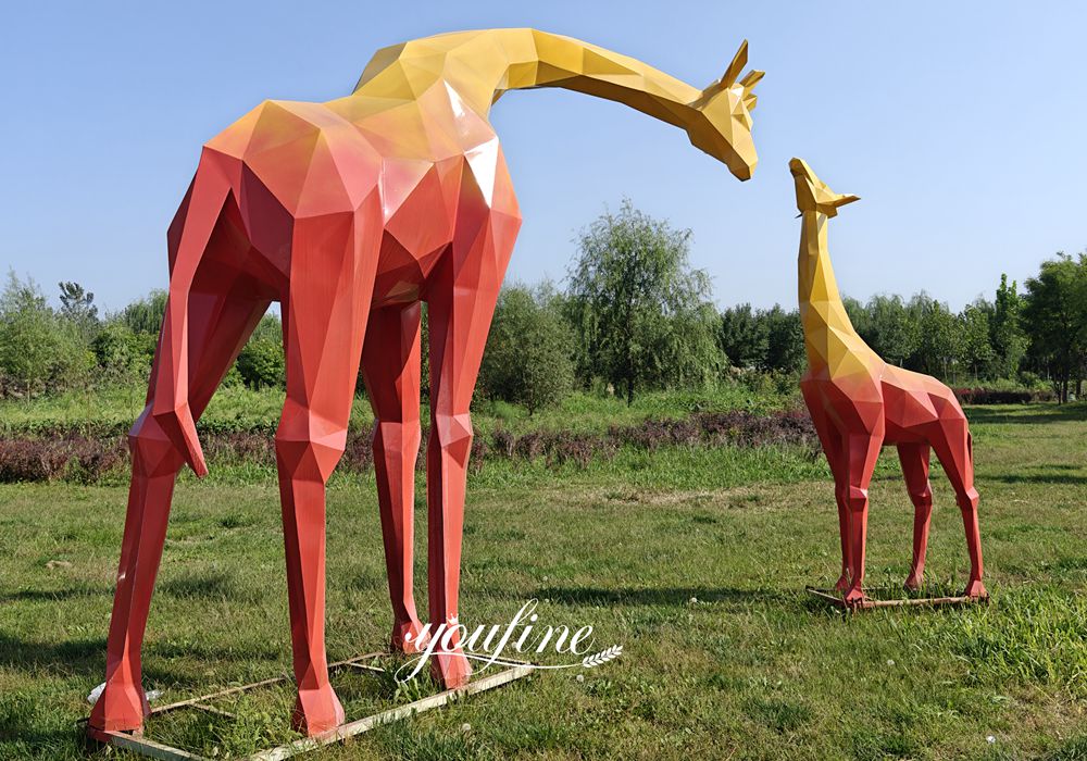 colorful geometric mother and baby giraffe statues