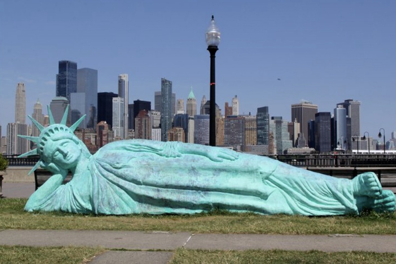 lying bronze liberty statue