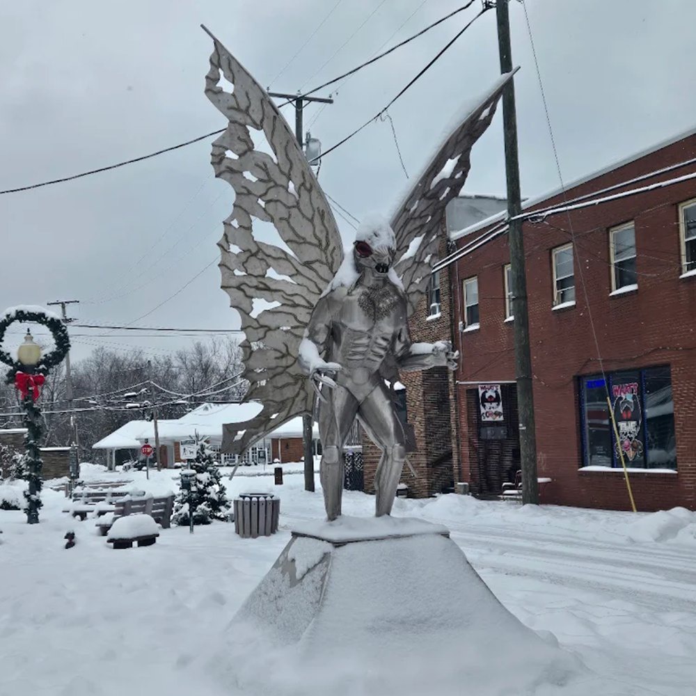 stainless steel Mothman statue in winter