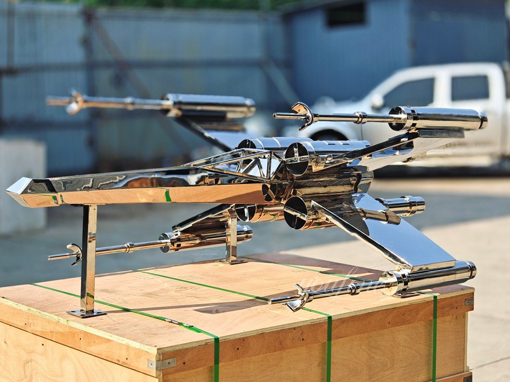 stainless steel X-wing fighter jet sculpture side view