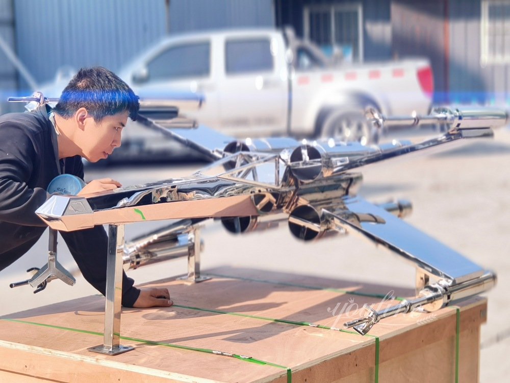 stainless steel X-wing fighter jet sculpture